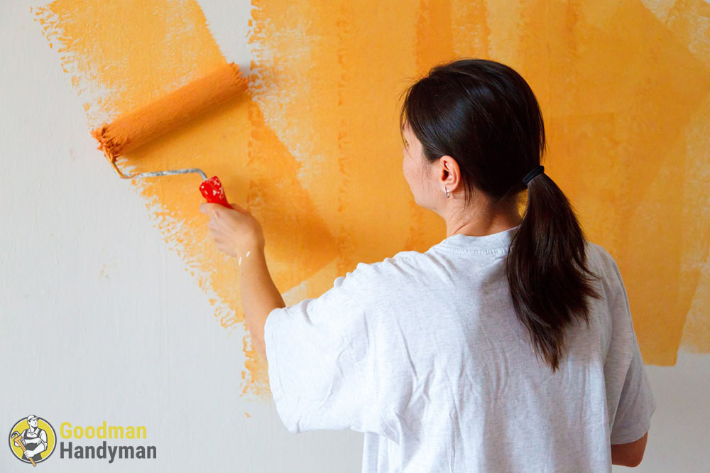 Woman painting the wall